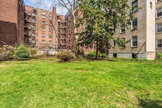 view of apartment building / complex featuring fence
