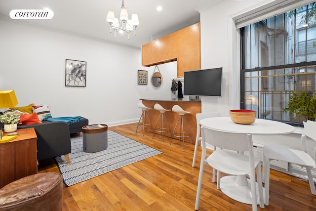 322 6th St Unit 5, New York City, NY 11215 - living room featuring wood finished floors, a chandelier, ornamental molding, baseboards, and recessed lighting
