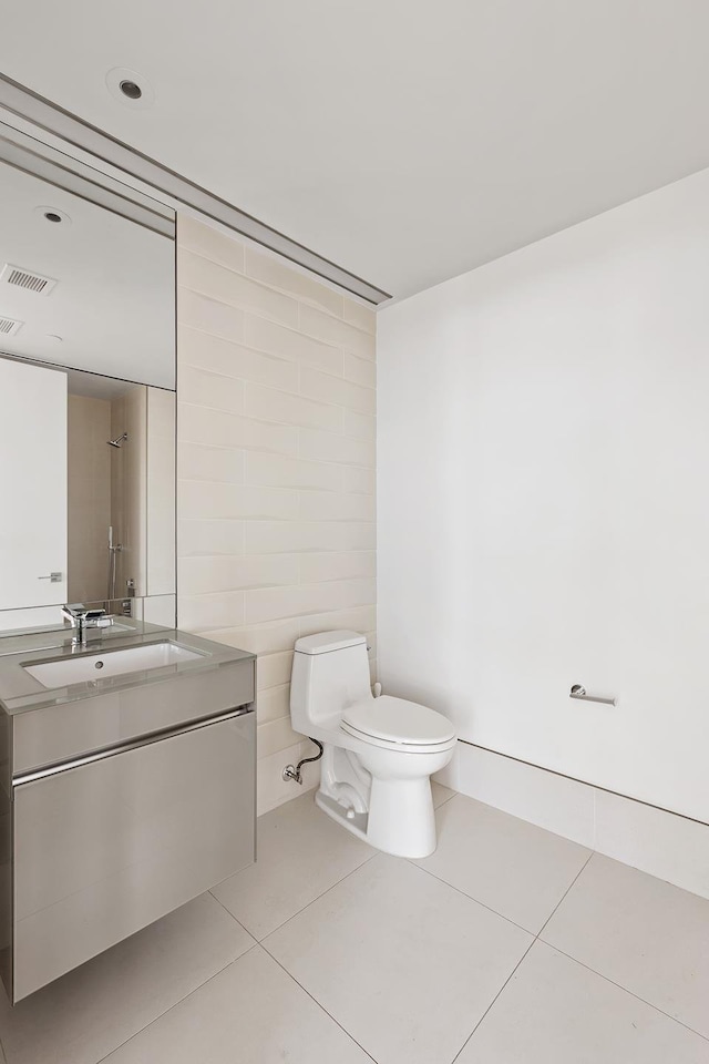 bathroom with tile patterned floors, vanity, and toilet