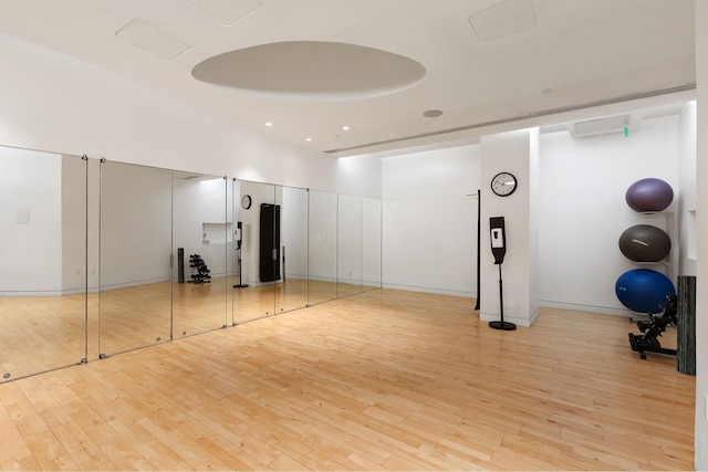 exercise room with light wood finished floors