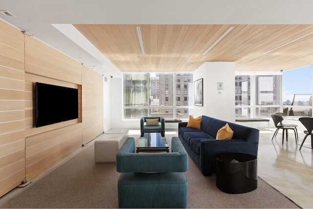 community lobby featuring wood ceiling, floor to ceiling windows, and wood walls