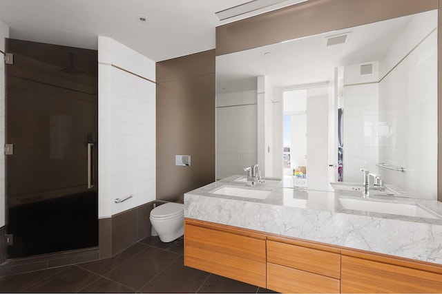full bathroom with a shower stall, toilet, tile patterned floors, and double vanity