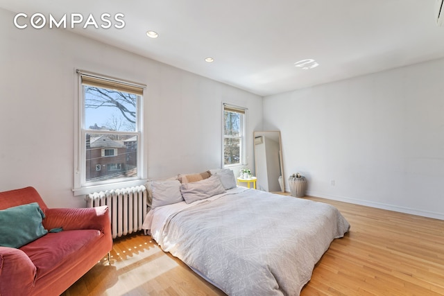 227 W 260th St, New York City, NY 10471 - bedroom with radiator heating unit, light wood finished floors, recessed lighting, and baseboards
