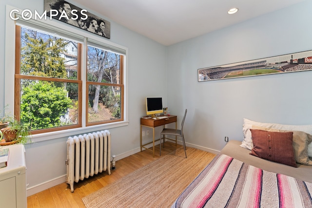 227 W 260th St, New York City, NY 10471 - bedroom with radiator heating unit, light wood finished floors, baseboards, an office area, and recessed lighting