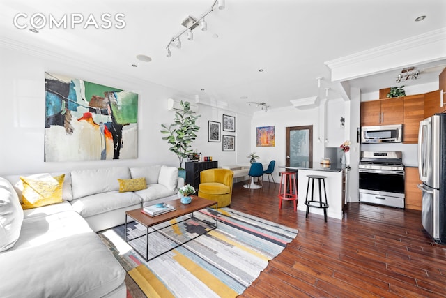 living area with ornamental molding and wood finished floors