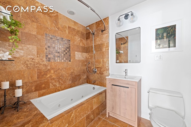 bathroom with a combined bath / shower with jetted tub, toilet, tile patterned floors, and vanity
