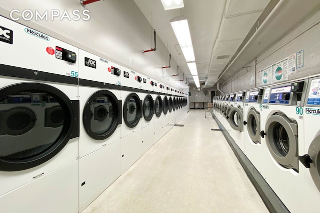 community laundry with independent washer and dryer and light flooring