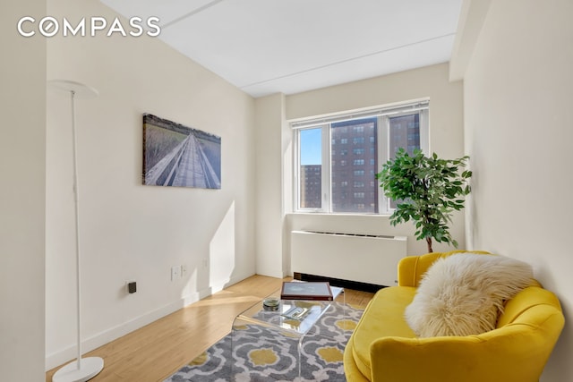 1810 3rd Ave Unit A7D, New York City, NY 10029 - sitting room featuring radiator, wood finished floors, and baseboards