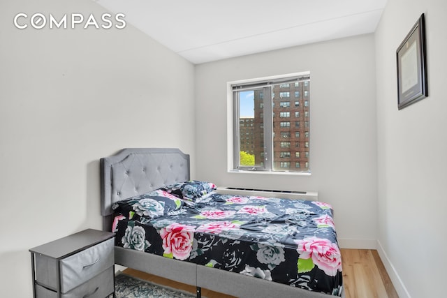 1810 3rd Ave Unit A7D, New York City, NY 10029 - bedroom featuring wood finished floors and a baseboard radiator