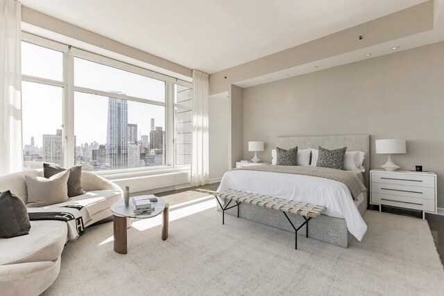 bedroom with a skyline view and multiple windows