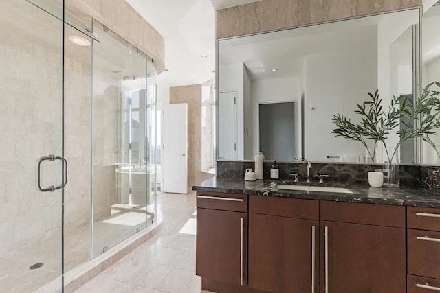 full bath with a stall shower and vanity