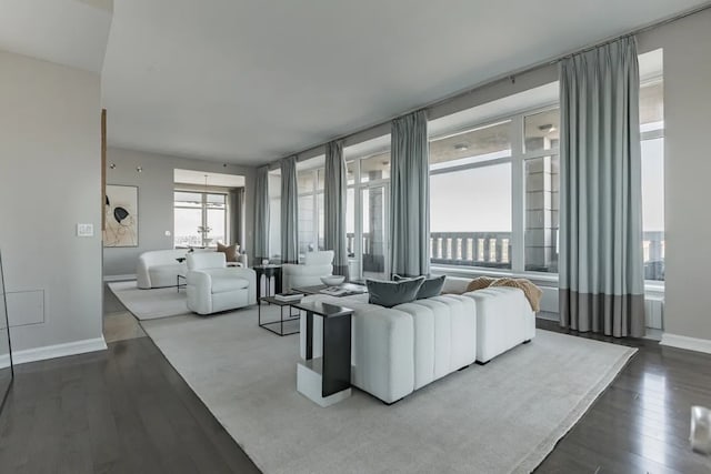 living area featuring dark wood-type flooring and baseboards