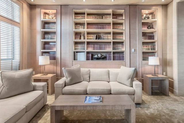 sitting room with built in features, recessed lighting, and carpet flooring