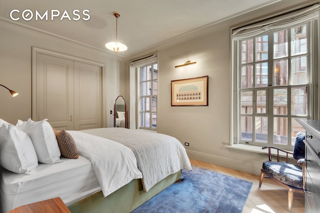 bedroom featuring baseboards, a closet, and wood finished floors