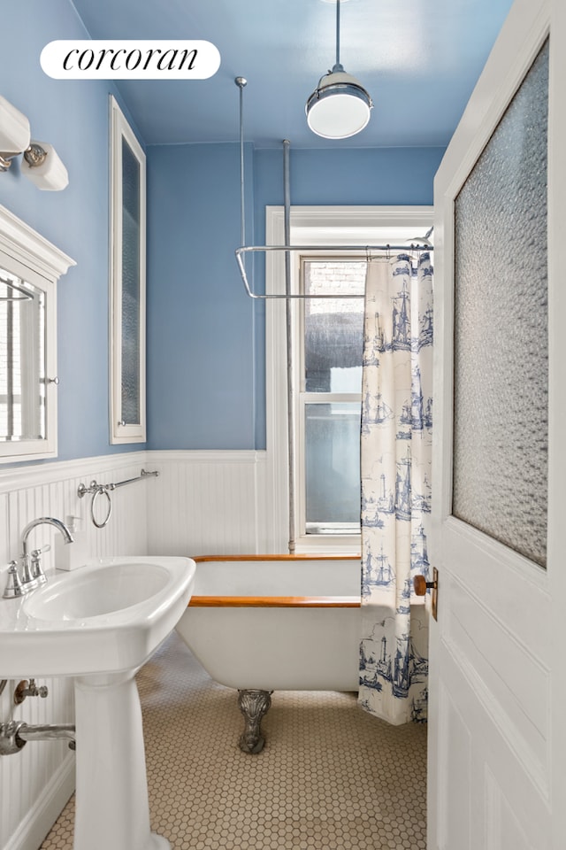 232 President St Unit 4R, New York City, NY 11231 - bathroom with wainscoting, a soaking tub, and curtained shower