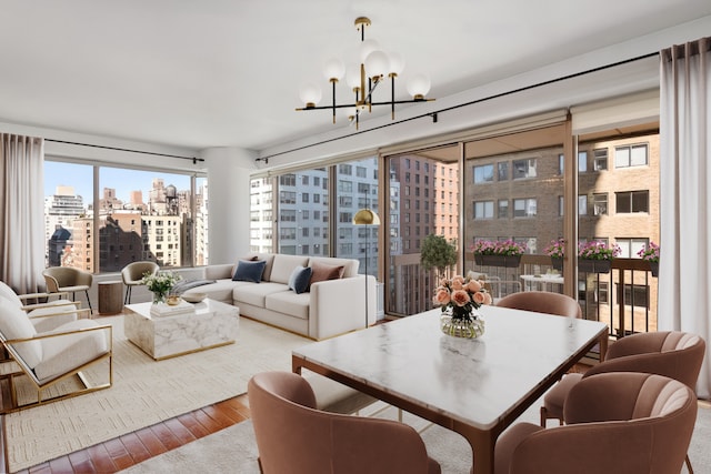 living room featuring a city view, a chandelier, and hardwood / wood-style floors
