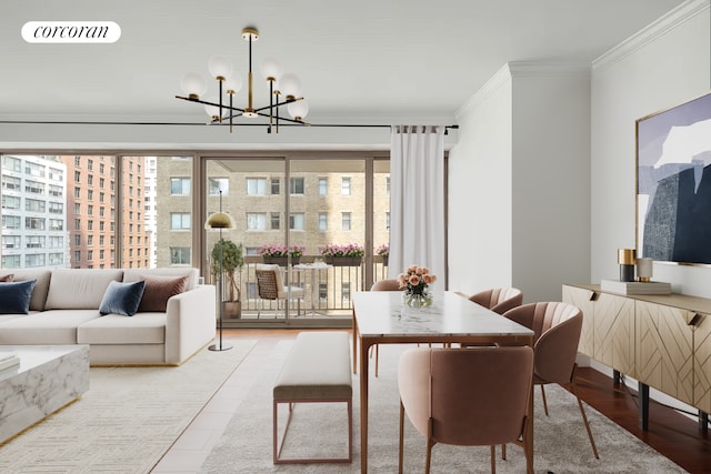 dining space with crown molding, a chandelier, and wood finished floors