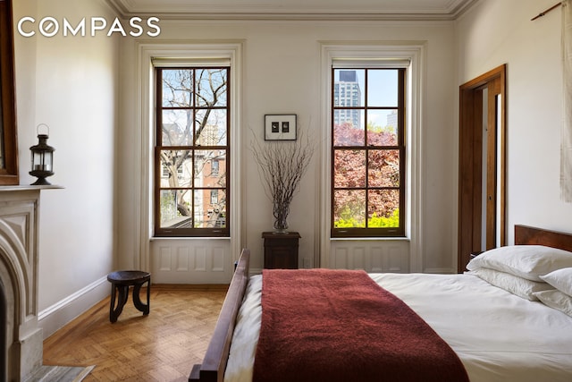 bedroom with crown molding and baseboards
