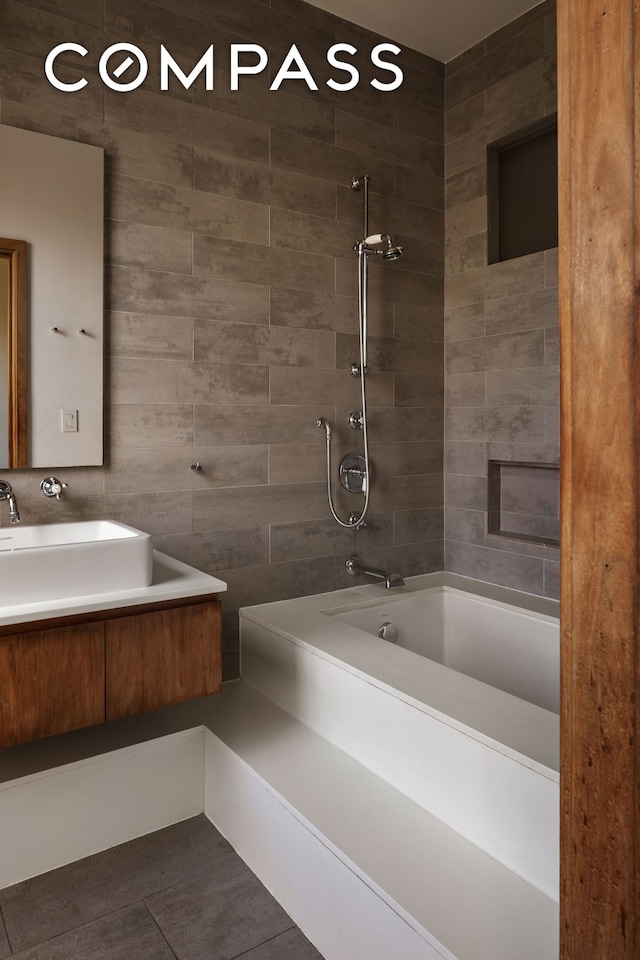 bathroom with bathtub / shower combination, tile patterned floors, and vanity