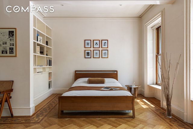 bedroom featuring crown molding and baseboards