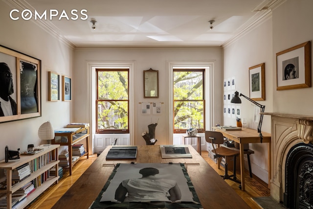 workout room featuring wood finished floors and crown molding
