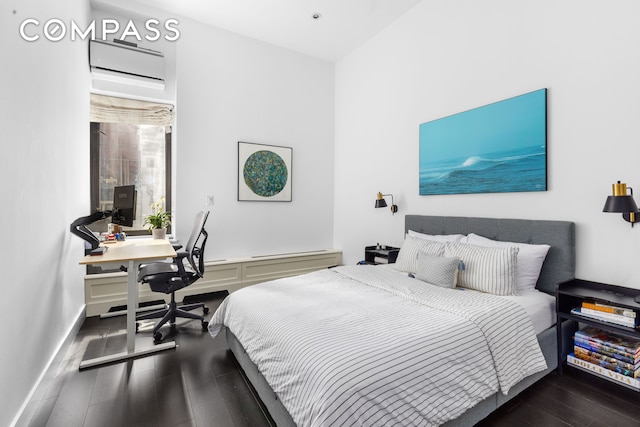 372 5th Ave Unit 5F, New York City, NY 10018 - bedroom featuring an AC wall unit, wood finished floors, and a desk