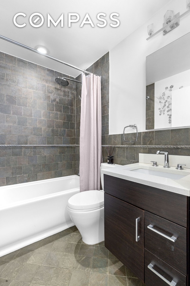 372 5th Ave Unit 5F, New York City, NY 10018 - bathroom with tile walls, vanity, and shower / tub combo with curtain