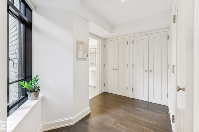 130 W 12th St Unit 1A, New York City, NY 10011 - hall featuring dark wood-type flooring, baseboards, and plenty of natural light