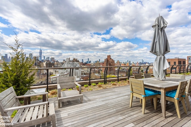 130 W 12th St Unit 1A, New York City, NY 10011 - wooden terrace with a view of skyline and outdoor dining space