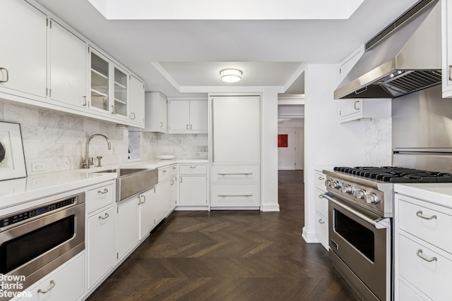 130 W 12th St Unit 1A, New York City, NY 10011 - kitchen with stainless steel appliances, extractor fan, a sink, light countertops, and backsplash