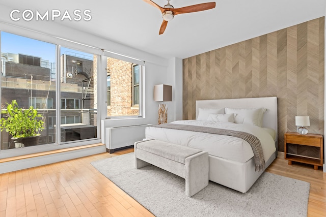 146-148 W 22nd St Ph, Ph, New York City, NY 10011 - bedroom with wallpapered walls, an accent wall, wood finished floors, and ceiling fan