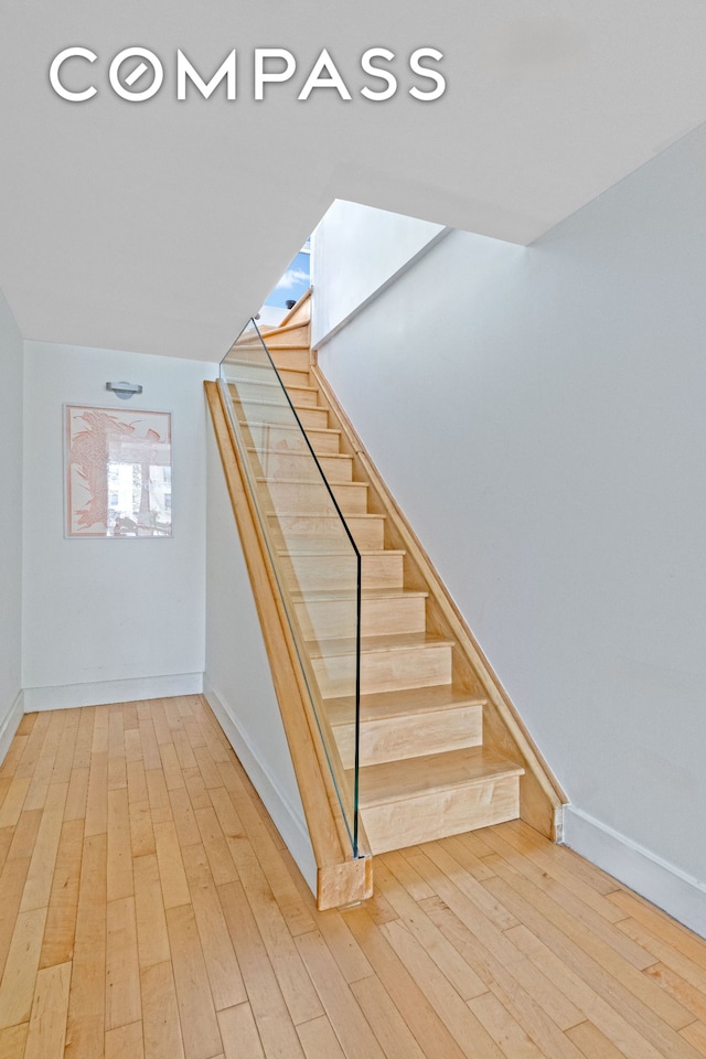 146-148 W 22nd St Ph, Ph, New York City, NY 10011 - staircase featuring wood-type flooring and baseboards