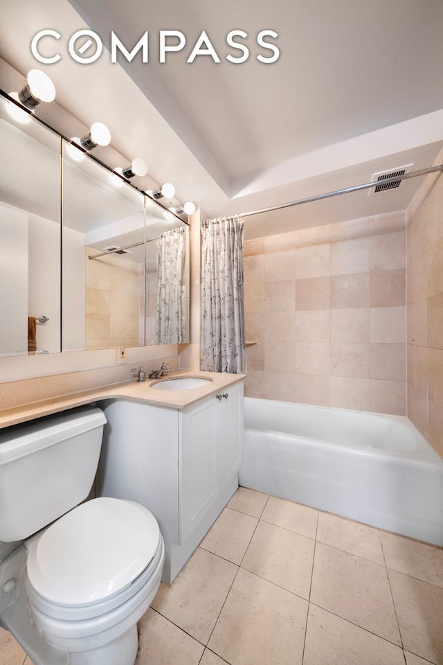 full bathroom with shower / tub combo with curtain, toilet, tile patterned flooring, and vanity