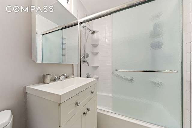 680 Washington St Unit 1B, New York City, NY 10014 - bathroom featuring toilet, vanity, and shower / bath combination with glass door