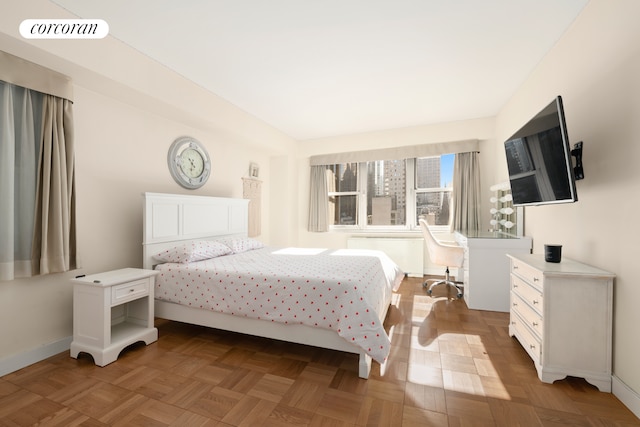 bedroom featuring radiator heating unit and baseboards