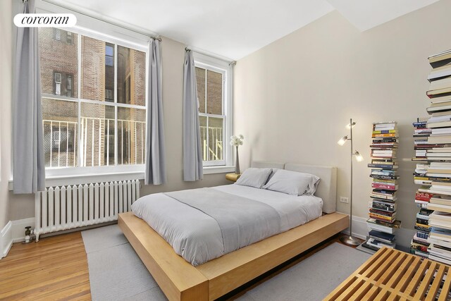 50 Pine St Unit Ph12N, New York City, NY 10005 - bedroom with radiator heating unit and light wood-style flooring