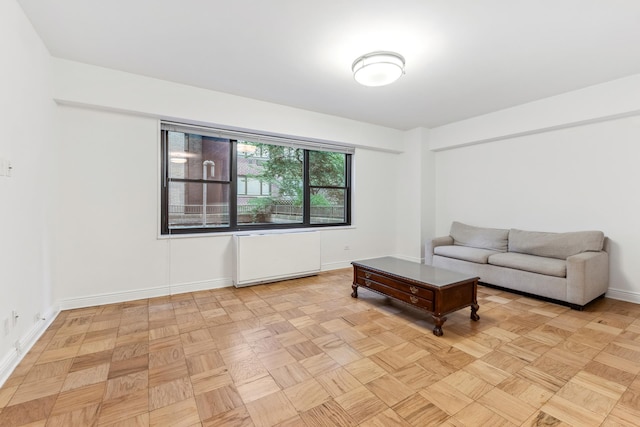 living area with radiator and baseboards