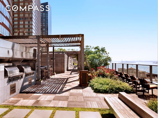 view of patio featuring an outdoor kitchen, area for grilling, and a pergola