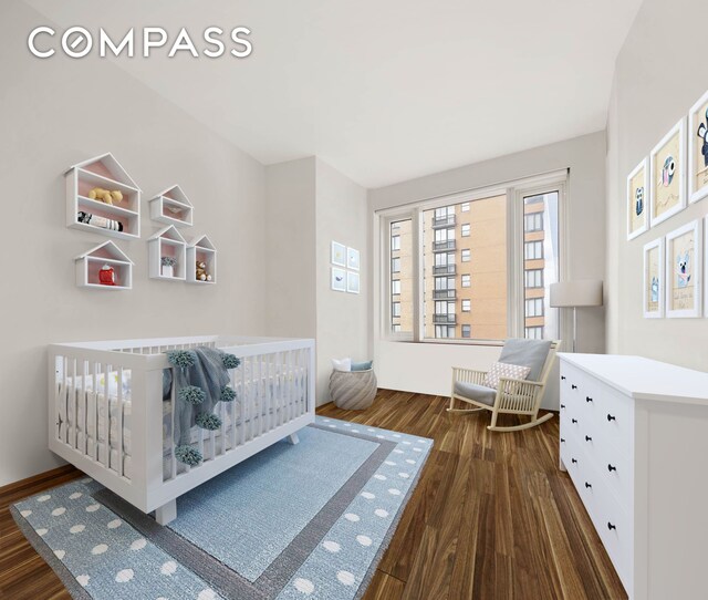 bedroom featuring dark wood-style floors and a crib