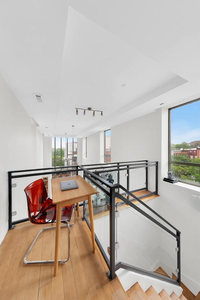 rec room featuring light wood-type flooring, baseboards, and track lighting