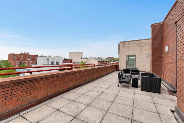 view of patio featuring outdoor dining space and a balcony