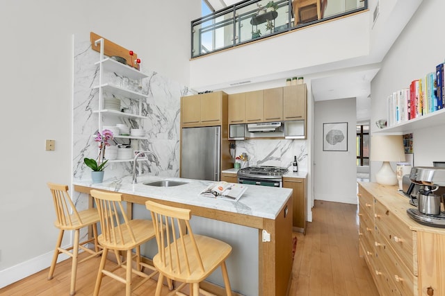 200 16th St Unit 4A, New York City, NY 11215 - kitchen featuring built in fridge, a sink, gas stove, under cabinet range hood, and a peninsula