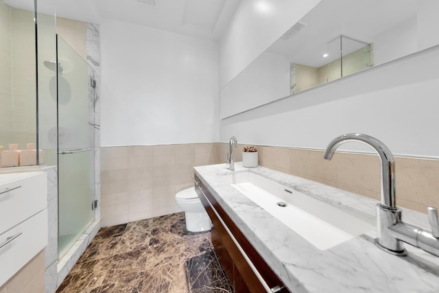 200 16th St Unit 4A, New York City, NY 11215 - bathroom with vanity, a shower stall, toilet, tile walls, and wainscoting