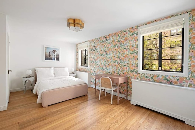 163 E 78th St, New York City, NY 10075 - bedroom featuring wallpapered walls, multiple windows, light wood-style flooring, and baseboards