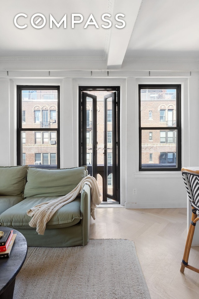 bedroom with access to outside, multiple windows, and ornamental molding