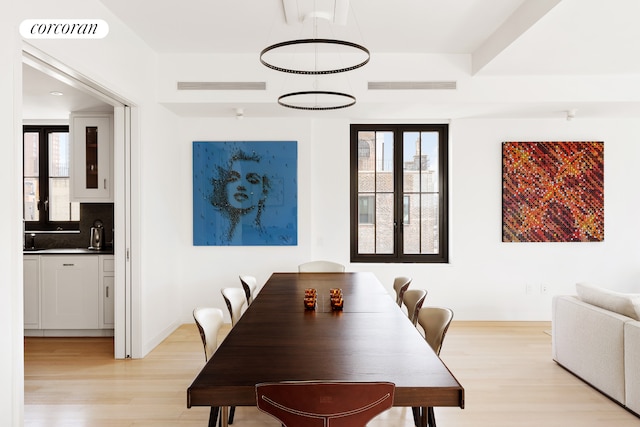 dining space featuring light wood-style flooring