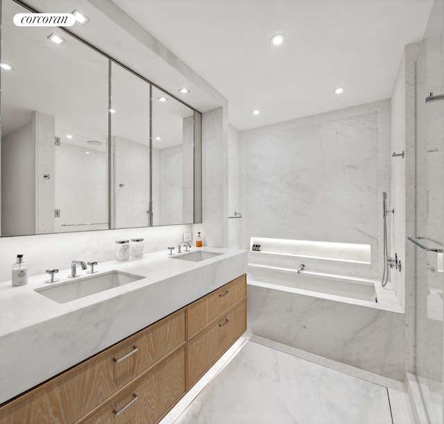 full bathroom with marble finish flooring, a bath, double vanity, and recessed lighting