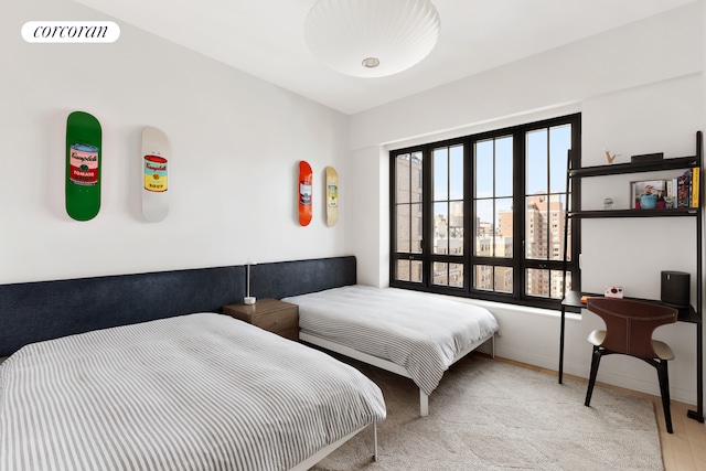 bedroom featuring carpet and baseboards