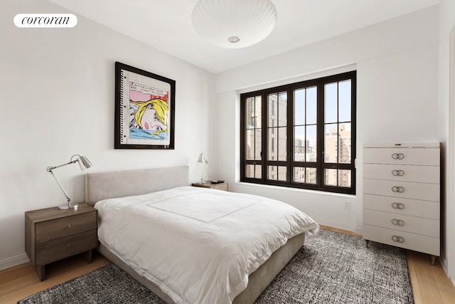 bedroom featuring light wood-style flooring and baseboards