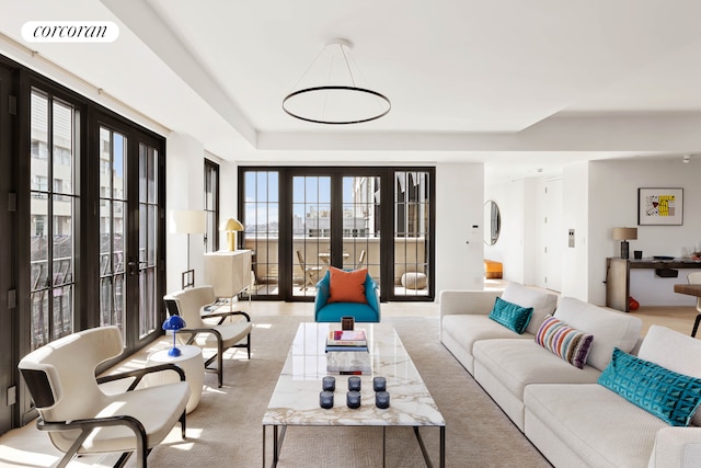 living room featuring french doors, healthy amount of natural light, and carpet flooring